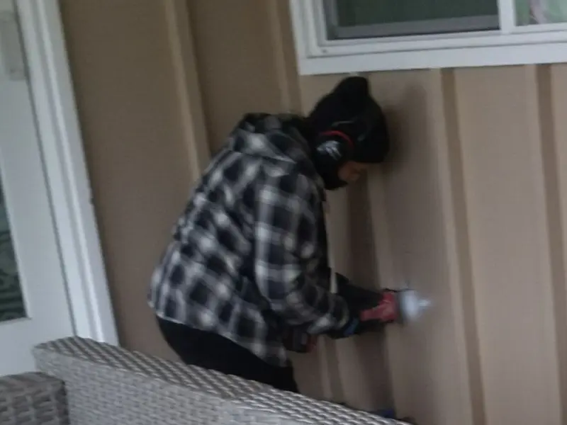 Professional electrician installing an exterior outlet in Ross