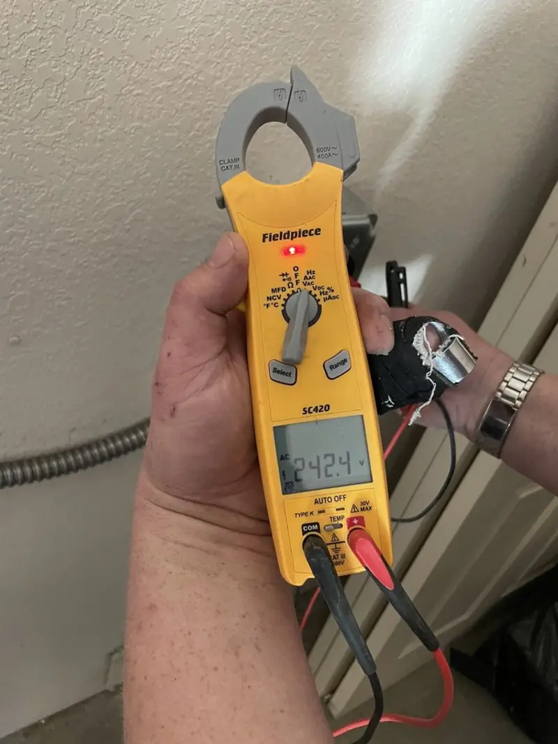 Voltage testing with clamp meter during Outlet Installation in Ross